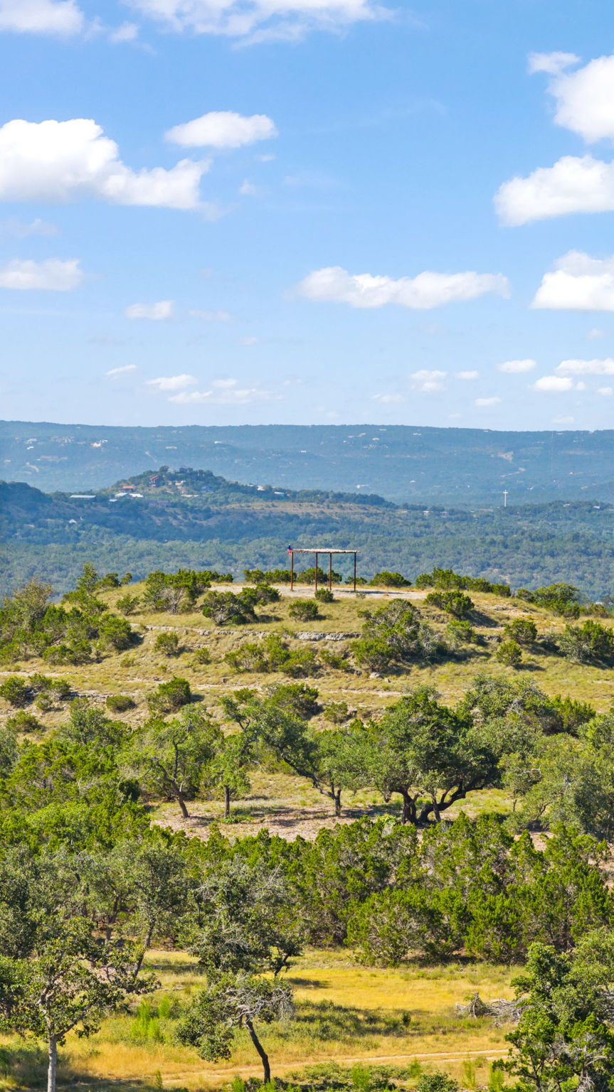 Long-range Hill Country view across the Lone Woman Mountain overlook at RanchesAt Driftwood